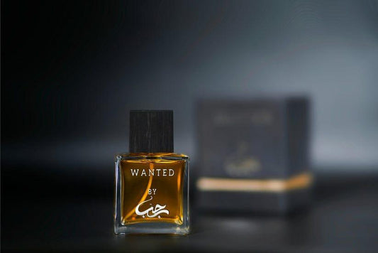 Perfume bottle labeled 'Wanted' with a blurred box in the background