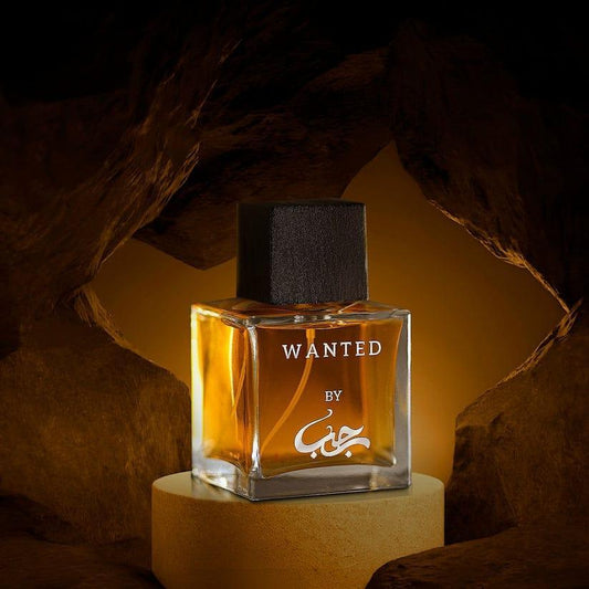 Perfume bottle labeled 'Wanted' by a brand on a dark background