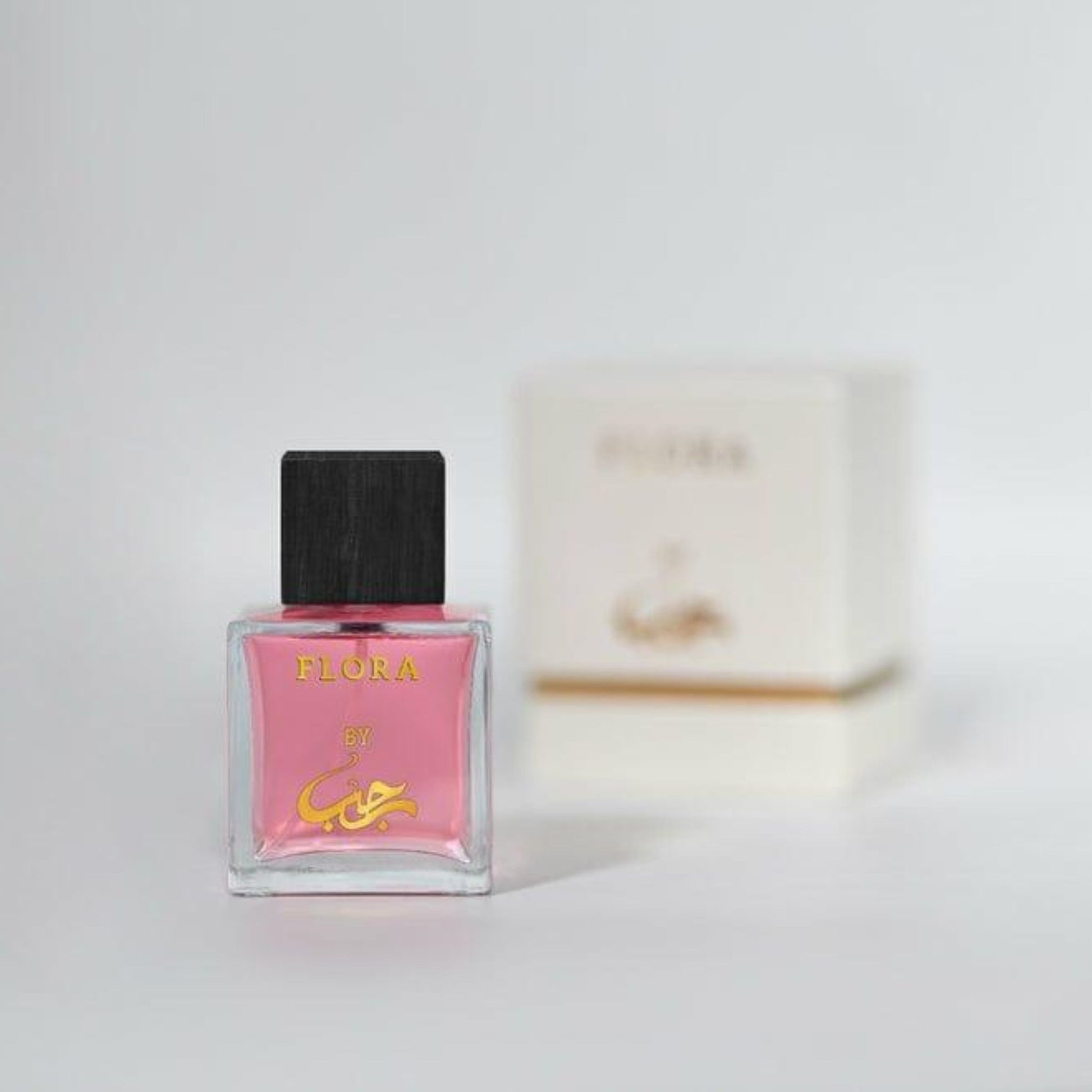 Perfume bottle labeled 'Flora' on a light background